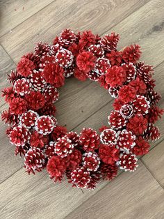 a wreath made out of pine cones on the floor