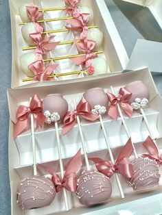 there are many pink and white cake pops in the box