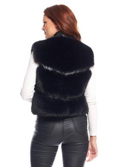 If you add just a single piece to your Winter wardrobe, our La Moda vest may be this season's most valuable update! In versatile Black Fox, it's tactile, touchable and silky soft. Fun, lightweight and falling just below the waist at 20", our Black Fox La Moda vest is understated perfection. Black pebblegrain vegan leather defines the four angled zippers, two of which are pockets, perfectly complementing the lavish Black Fox fur. A small leather standup collar transistions to leather bands along the center fronts, set with three silver snap closures. Leather pulls finish the decorative upper zippers as well as the functioning lower pockets. The chevron-like fur pelts are repeated in back, also defined by narrow leather strips. Flattering deep-cut armholes eliminate any hint of bulk and guar Chic Solid Color Vest For Winter, Fitted Vest For Winter Layering, Chic Stretch Vest For Fall, Elegant Stretch Vest For Fall, Black Fox, Fabulous Furs, Thick Sweaters, Fake Fur, Leather Pulls