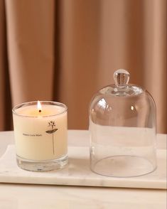 a candle is sitting next to a glass jar