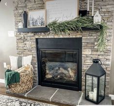 a living room with a fire place and pictures on the wall above it's mantle