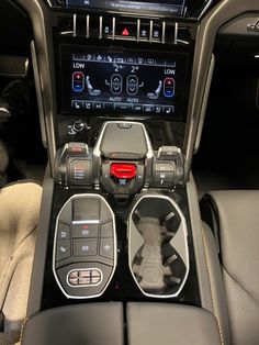 the interior of a car with an automatic gear box and steering wheel controls on display