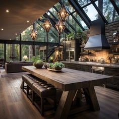 a large wooden table sitting in the middle of a kitchen next to a stove top oven