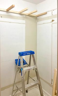 a ladder is sitting in the corner of a room