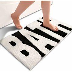 a person standing on top of a bath mat