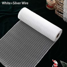 white - silver wire mesh on black background with christmas decorations and other items in the background