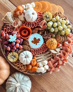 a platter filled with lots of different types of food on top of a wooden table