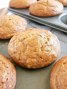 freshly baked muffins lined up on a baking tray