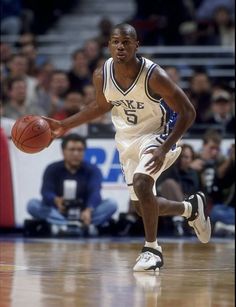 a basketball player dribbling the ball during a game