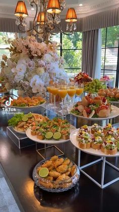 a buffet table filled with different types of food and drinks on it's trays