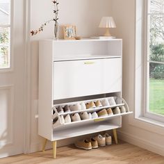 a white shoe rack with several pairs of shoes on it in front of a window