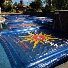 inflatable sun signs on the side of a swimming pool