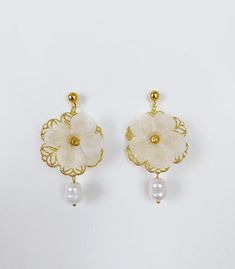 *Use discount FOURITEMS to get 10% off when you purchase 4 or more items (valid with jewelry, ceremony item, etc) * Designed and handcrafted in the Philippines by Filipino women artisans * Gold-plated brass studs with secure lock backs * Made of stainless steel gold plated hardware, handcrafted silk organza flowers characterized with sheerness that complements one's elegance, and baroque South Sea pearls, locally sourced from Cebu City in the Philippines to support traditional crafts * 2 inches in length, lightweight to wear all day * Each piece features 'intentional imperfections' - variations in exact size, cut, color, texture, and patterns. This adds to the individuality and unique story of each piece. Pearls are baroque and irregularly shaped, just as nature intended and may not exactl Filipino Pearl Jewelry, Traditional Filipino Jewelry, Handmade Delicate Yellow Gold Pearl Earrings, Delicate Handmade Yellow Gold Pearl Earrings, Delicate Handmade Gold Pearl Earrings, Gold Plated Flower Earrings For Weddings, Gold Plated Round Flower Earrings For Wedding, Elegant Gold Flower Earrings For Wedding, Handmade Gold Pearl Earrings For Gift