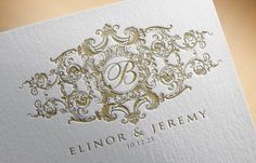 a white and gold wedding card with the letter b on it's front side