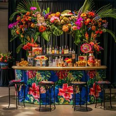 the bar is decorated with colorful flowers and tropical foliages for an event or celebration