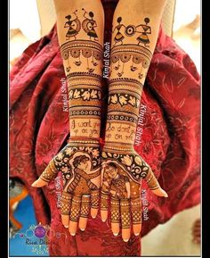 two hands with henna designs on them