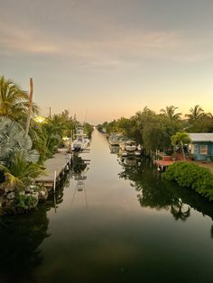 boats are docked at the end of a canal