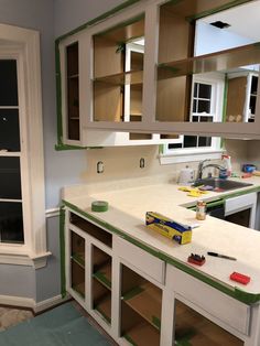 the kitchen counter is being painted green and white