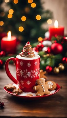 a red cup filled with hot chocolate on top of a plate next to a christmas tree