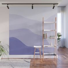 a living room with a wall painted in shades of blue and purple, including mountains