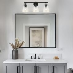 a bathroom with two sinks and a large mirror