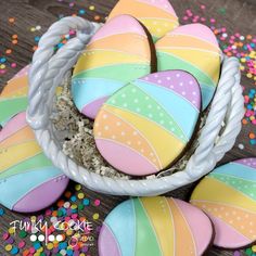 decorated easter eggs in a basket on a table