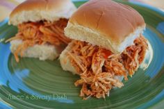 two pulled pork sandwiches on a blue plate