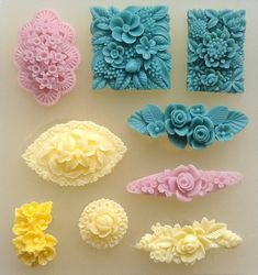 there are many different types of flowers on the table together, including soaps and fondant