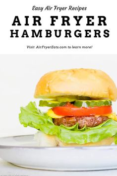 an air fryer hamburger on a plate with lettuce and tomatoes