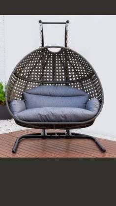 a chair that is sitting on top of a wooden floor next to a potted plant