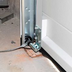 an electrical wire is attached to the side of a door with a screwdriver