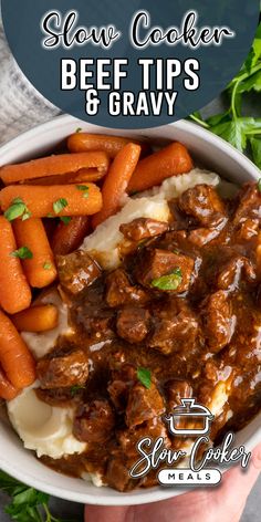 a bowl full of beef and gravy with carrots on the side next to some parsley