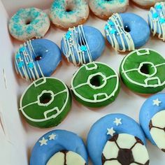 there are many decorated doughnuts in the box