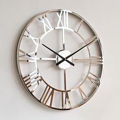 a large metal clock with roman numerals on the face