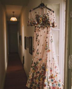 a dress hanging up on a door way