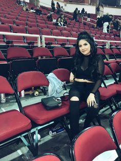 a woman sitting in the middle of a stadium