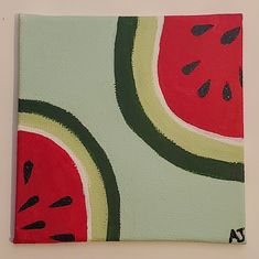 a painting of watermelon slices on a white wall