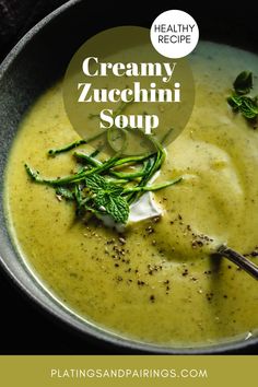 creamy zucchini soup in a bowl with a spoon