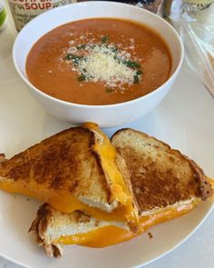 grilled cheese and tomato soup are served on toasted bread with parmesan cheese