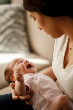 a woman holding a baby in her lap