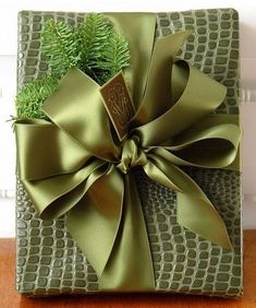 a present wrapped in green paper with a bow