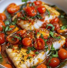 some fish with tomatoes and herbs in a bowl