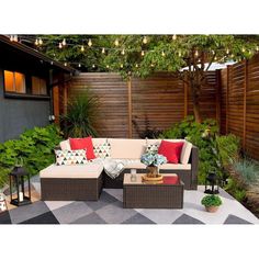 an outdoor living area with furniture and plants