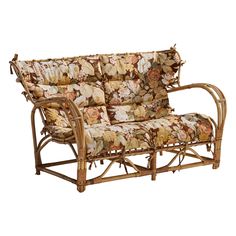 a couch that is made out of bamboo and has floral fabric on the backrest