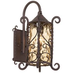 a light fixture with an ornate iron frame and glass panels on the outside of it