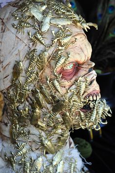 a close up of a person's face with many bugs on it