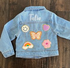 Hi there! Welcome to my shop. These unisex personalized embroidered denim jacket are available in toddler and children's sizes. These Custom denim jacket makes the best birthday or baby shower gift! Jacket is light wash and has a slightly oversized fit. Patches are SEWN ON so you can put these in the washer. Because these are one of a kind, returns are not accepted. Each item is made to order and machine embroidered by me so slight variations may occur. I am unable to replace/refund purchases ba Customizable Denim Jacket For Spring, Spring Customizable Denim Jacket, Customizable Cotton Denim Jacket For Fall, Customizable Blue Denim Jacket For Spring, Customizable Long Sleeve Denim Jacket, Customizable Spring Denim Jacket, Customizable Long Sleeve Denim Outerwear, Cute Cotton Denim Jacket With Pockets, Cute Denim Blue Cotton Outerwear