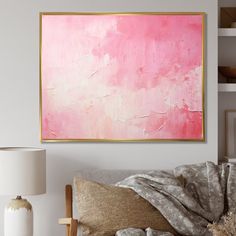 a living room with a couch, lamp and large pink painting on the wall above it