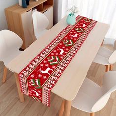 a christmas table runner with reindeers and snowflakes on it