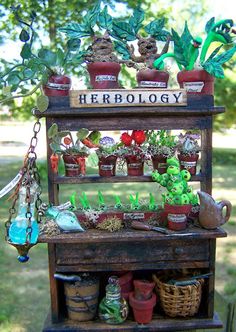 a shelf filled with potted plants on top of a grass covered field